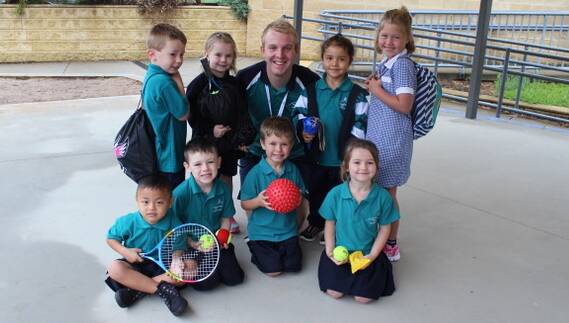 ACTIVE: Specimen Hill PE teacher Todd Broadbent with Prep students and items from their new PE kit bags to take home. Picture: CONTRIBUTED
