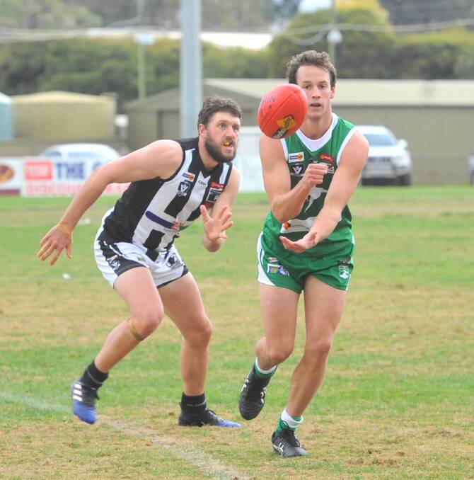 Kangaroo Flat's Alex Pearson handballs against Castlemaine on Saturday.