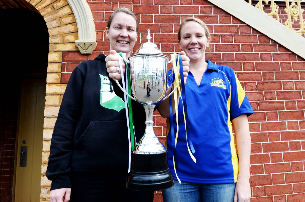 Kangaroo Flat's Karly Elvey and Golden Square's Belinda Pinner with the A-grade netball premiership cup. Picture: DARREN HOWE
