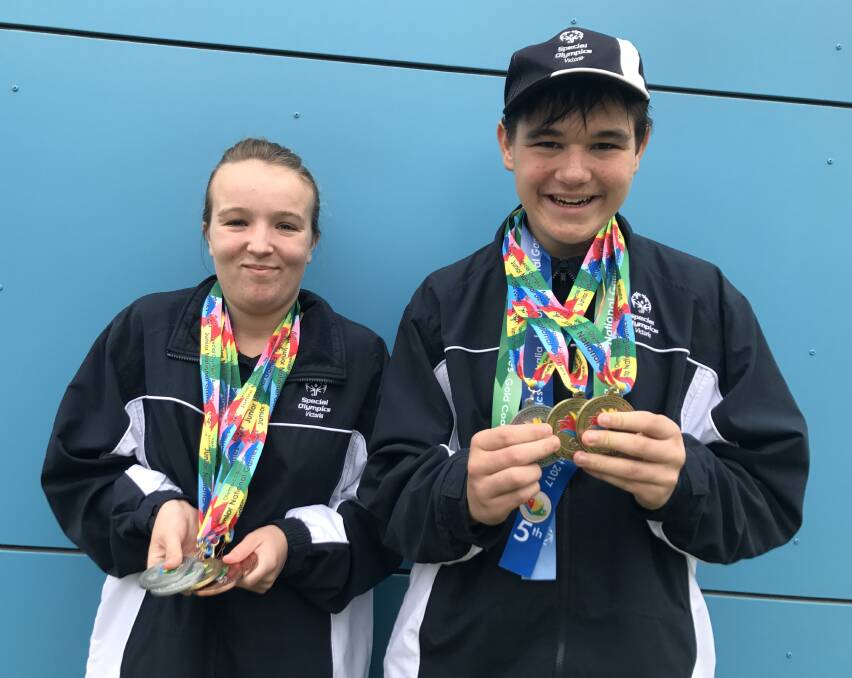HAUL OF MEDALS: Bendigo's Emily Spofforth and Jedd Manton have plenty to show for their efforts at the Special Olympics Junior National Games. Picture: LUKE WEST