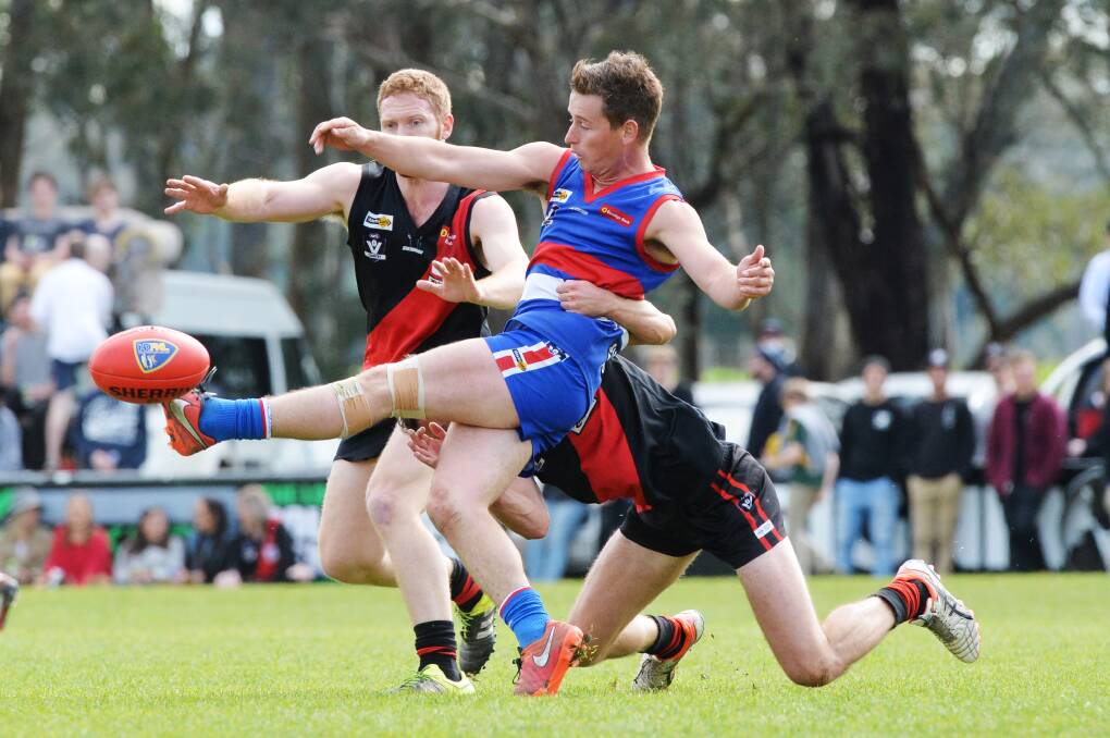 CLASSY: North Bendigo's Jarrod Findlay gets a kick away in last year's grand final win against Leitchville-Gunbower. The Bulldogs again loom as the team to beat this season as they chase a third flag in a row. Picture: DARREN HOWE