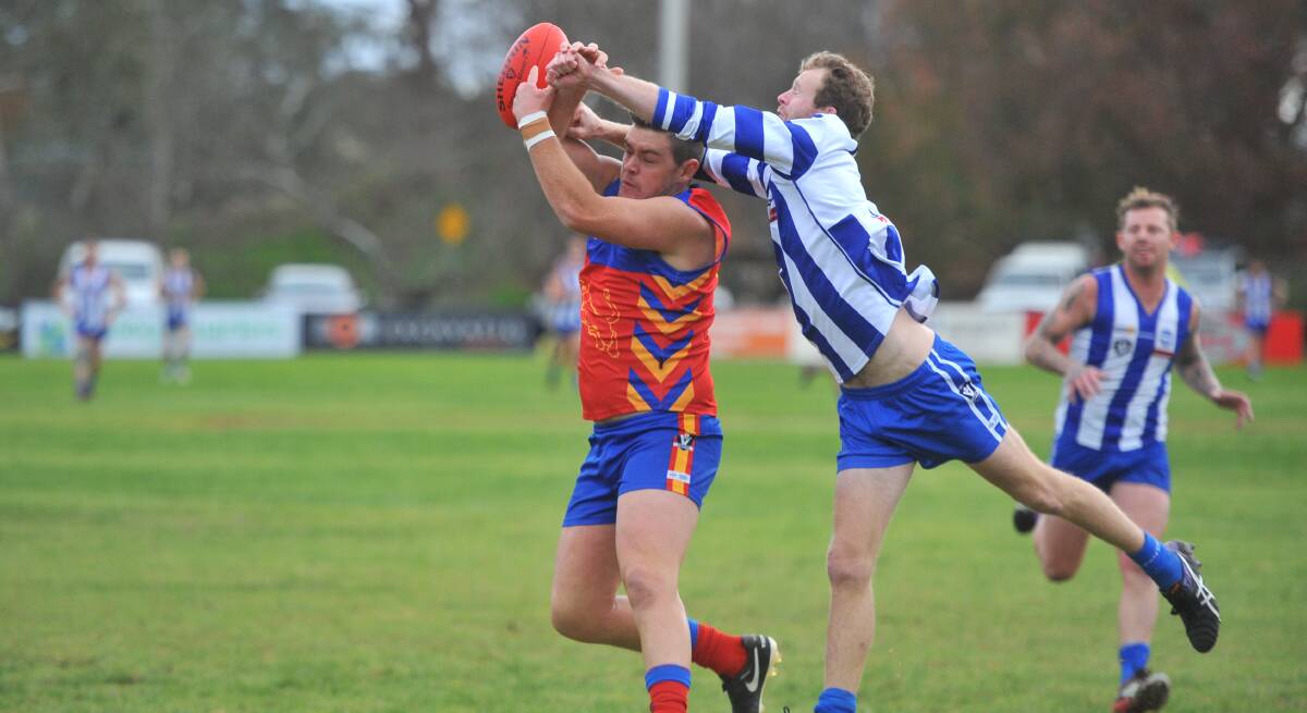 CONTEST: Mitiamo captain Dylan Clohesy tries to spoil Marong's Zac Turnbull in the first quarter on Saturday. The Superoos beat the Panthers by 15 points. Picture: LUKE WEST
