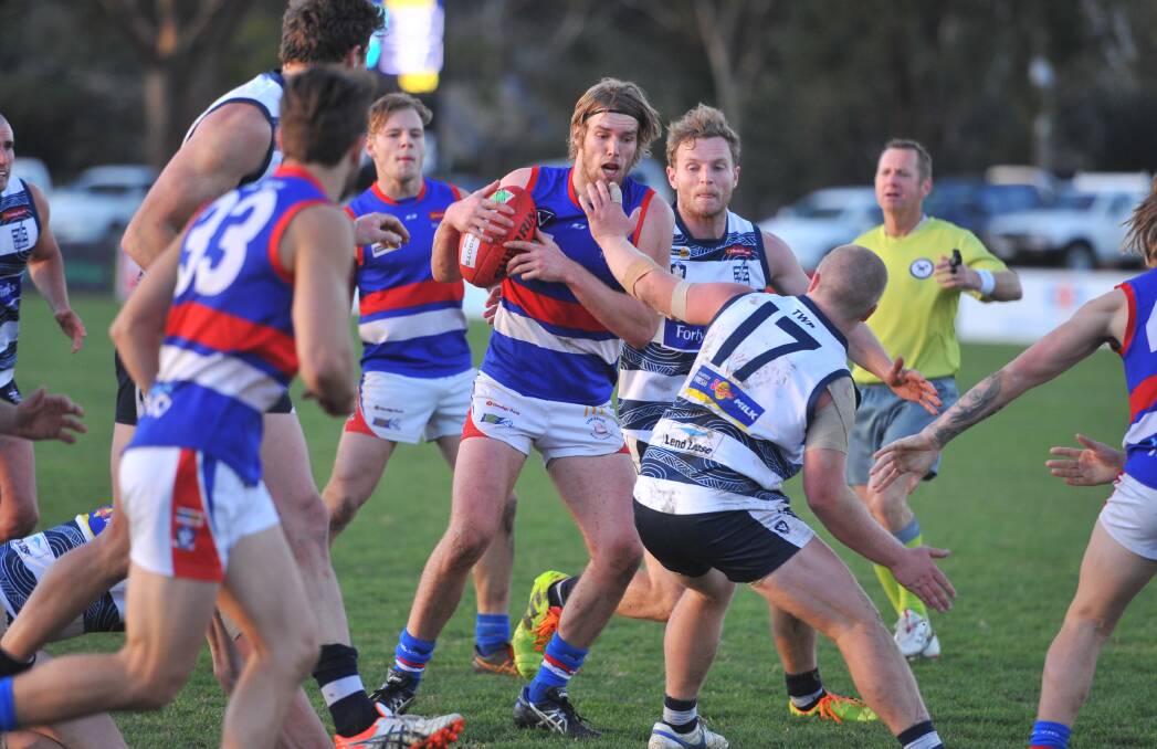 EVASIVE: Gisborne's Eamon McKenna takes possession of the ball from a stoppage during the last quarter of Saturday's game at Strathfieldsaye. Picture: LUKE WEST