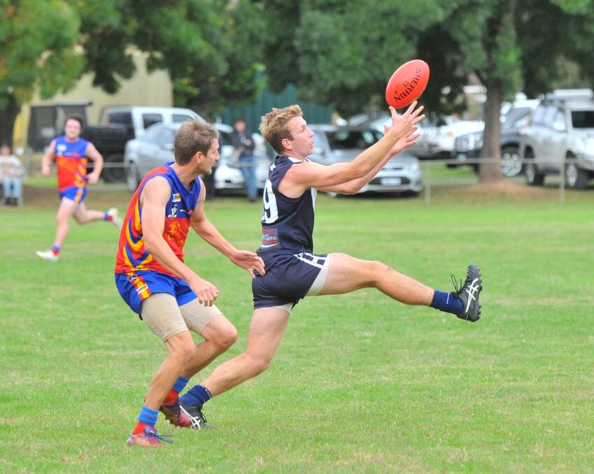 OUT IN FRONT: Inglewood forward Shane Harris stretches for a mark against Marong on Saturday. Harris bagged three goals for the Blues. Picture: ADAM BOURKE
