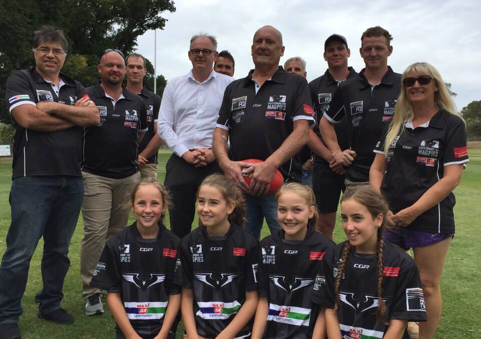 MAGPIES NEST: Jock Clark, pictured in the centre, has been appointed the new president of the Castlemaine Football-Netball Club. He's joined by fellow committee members and players at Wednesday's announcement at Camp Reserve. Picture: LUKE WEST