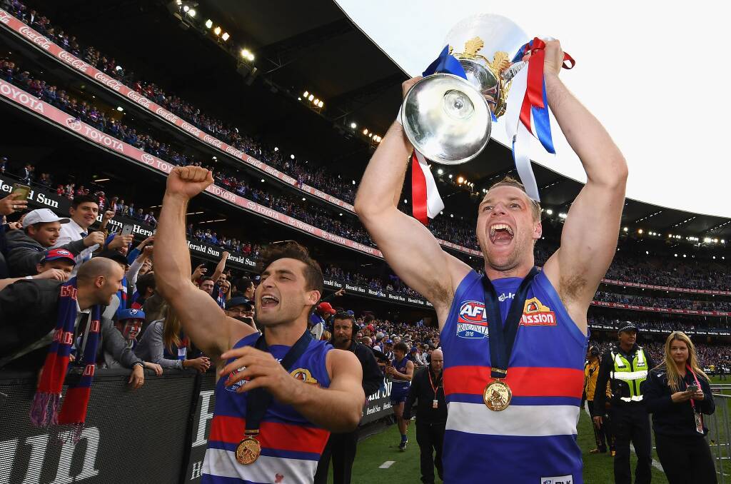 GRAND PRIZE: Jake Stringer holds aloft the AFL premiership cup after the Western Bulldogs beat Sydney by 22 points last Saturday. Picture: GETTY IMAGES