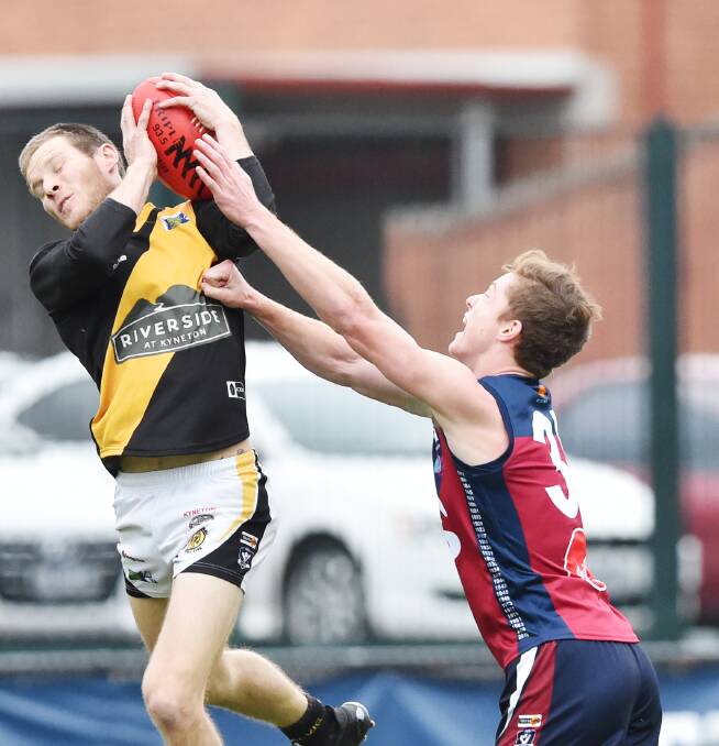 MAJOR INFLUENCE: Kyneton forward Ben Weightman marks at the QEO on Saturday in front of Josh Hann. Weightman provided plenty of highlights with five goals in the drawn game against Sandhurst. Picture: DARREN HOWE