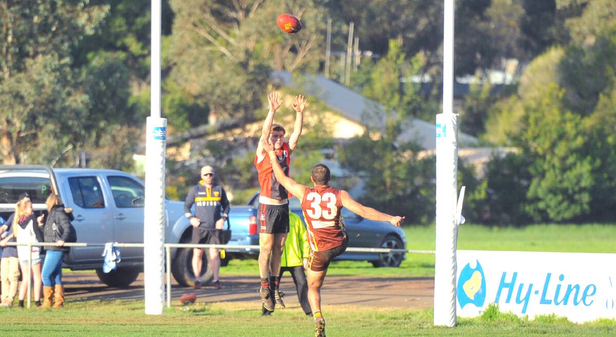 SET-SHOT: Huntly's Jacob Greenwood kicks at goal in the final quarter of Saturday's comfortable win over White Hills at home. The Hawks won 20.15 (135) to 3.10 (28). 
