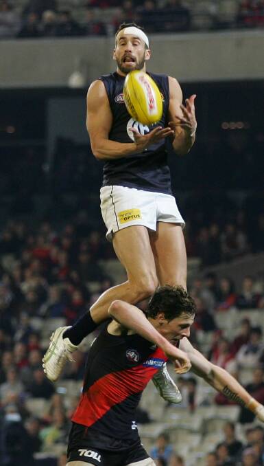 HIGH-FLYER: Andrew Walker took this spectacular grab over Essendon's Jake Carlisle at the MCG in 2011. How was it not mark of the year? Picture: GETTY IMAGES
