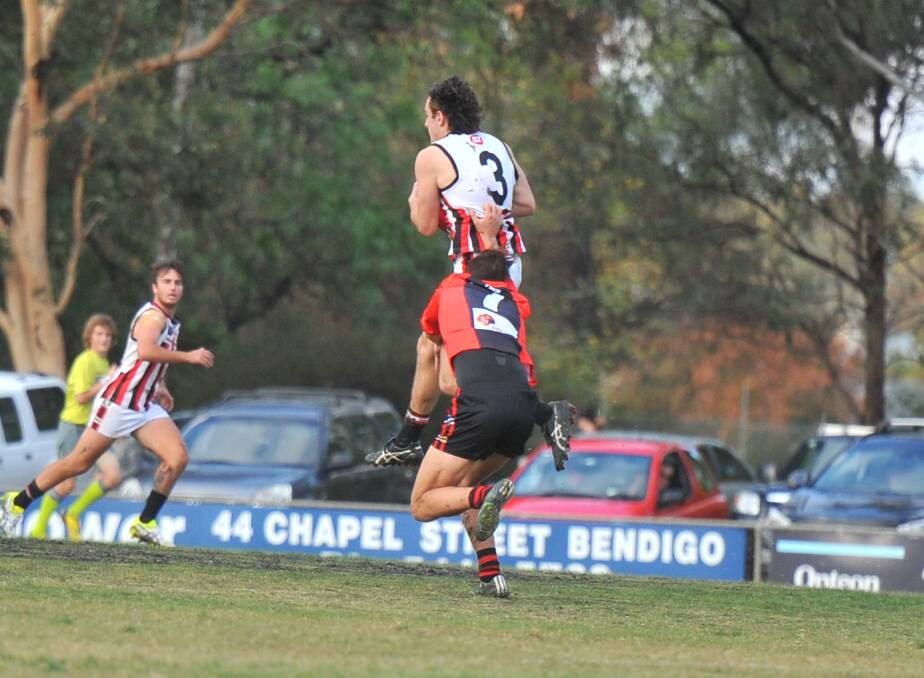ON THE LEAD: Heathcote's Jackson Bailey marks in front of White Hills' James Fox during Saturday's contest at Tint-a-Car Oval. The Demons were winners by 15 points, 13.12 (90) to 10.15 (75). Pictures: LUKE WEST
