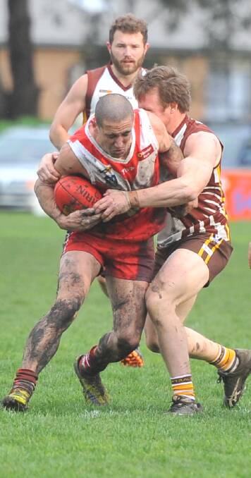 WRAPPED UP: Elmore's David Price is caught up in a tackle against Huntly on Saturday. The Bloods started well, but faded in the second half. Pictures: LUKE WEST