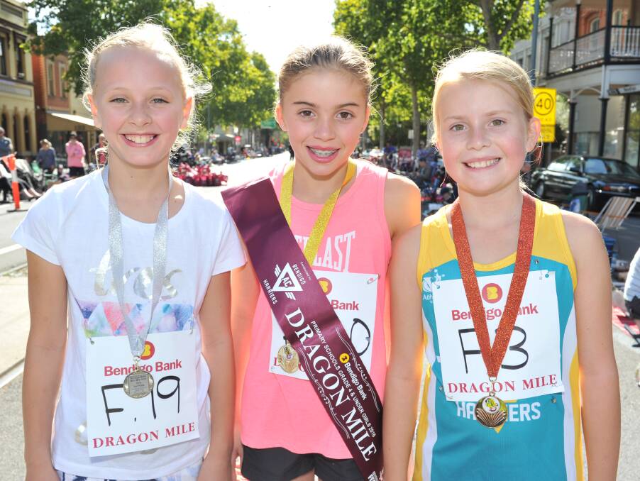 ALL SMILES: Lucia Painter, Megan Wilson and Zoe Banfield after the Year 4 and under female Mini Mile.