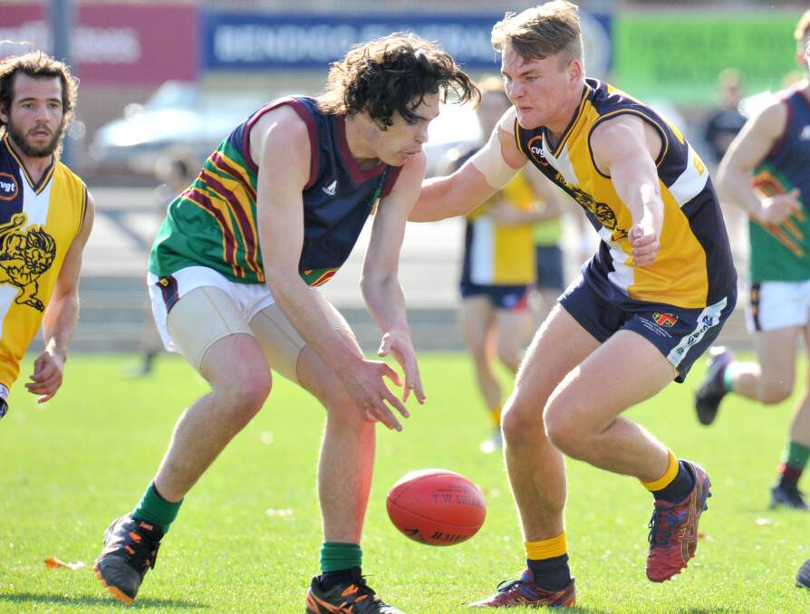 CONTESTED BALL: Catholic College Bendigo's Darby Graham and Bendigo Senior Secondary College's Jonty Neaves prepare to pounce on a loose ball at the QEO in Wednesday's school football clash. Picture: NONI HYETT