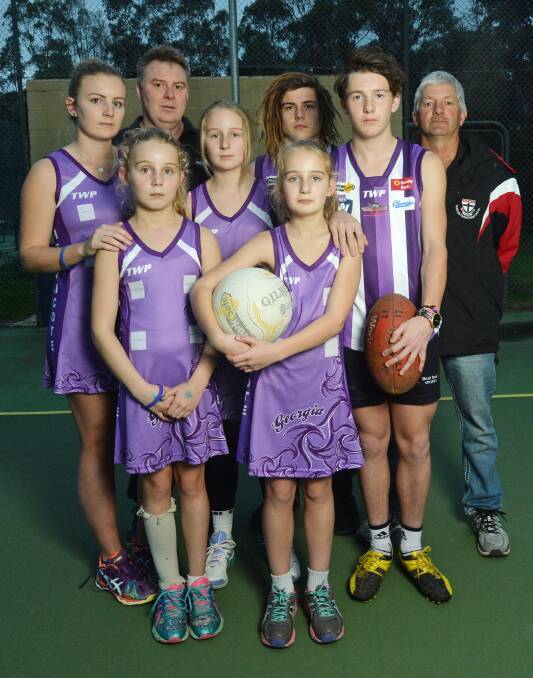 PURPLE TRIBUTE: Tayla, Lily, Grace and Matlida Edsall-French with Mark Segafredo, Dylan McCutcheon, Jackson Conforti and Andrew Conforti. Picture: DARREN HOWE