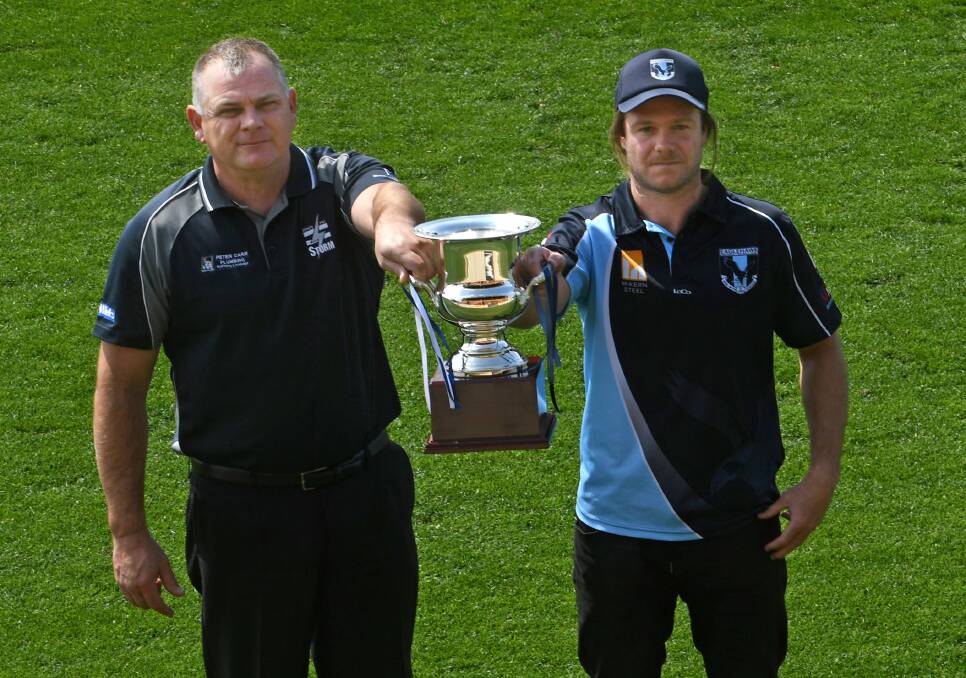 SILVERWARE: Strathfieldsaye coach Darryl Wilson and Eaglehawk coach Josh Bowe with the BFNL premiership cup. Picture: DARREN HOWE