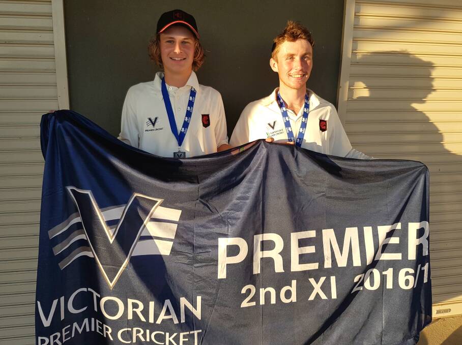SEE THE BOMBERS FLY UP: Essendon's James Ryan and Isaac Conway with their Premier Cricket second XI medals and the premiership flag won last weekend against Frankston Peninsula. Picture: CONTRIBUTED