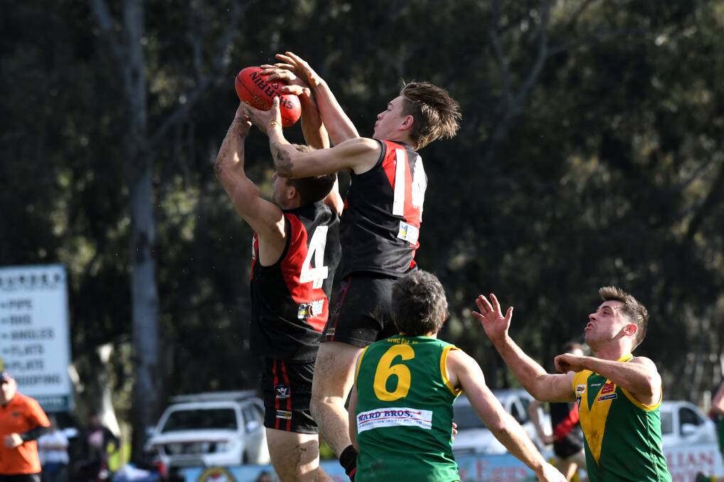 EYES FOR THE BALL: Leitchville-Gunbower's Matt Ladson (No.4) and Logan Prout (No.14) during Saturday's 52-point win over Colbinabbin. Picture: NONI HYETT