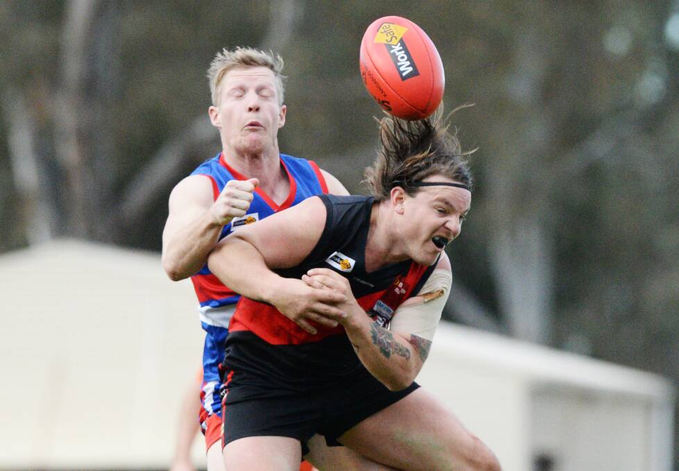 CONTEST: North Bendigo's Lachlan Ford and Leitchville-Gunbower's Liam Guinan tussle for possession on Saturday. The Bombers won by 26 points in front of a crowd that paid a gate of $50,000 at Huntly. Picture: DARREN HOWE