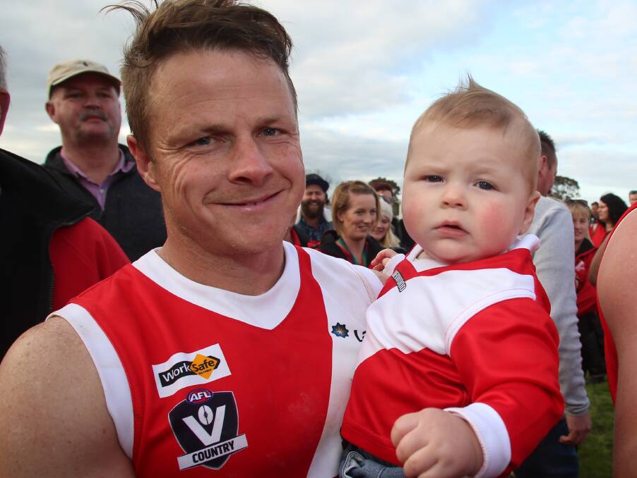 SEVEN TIMES A CHAMPION: Bridgewater's Deon Jones with son Perry, aged nine months.