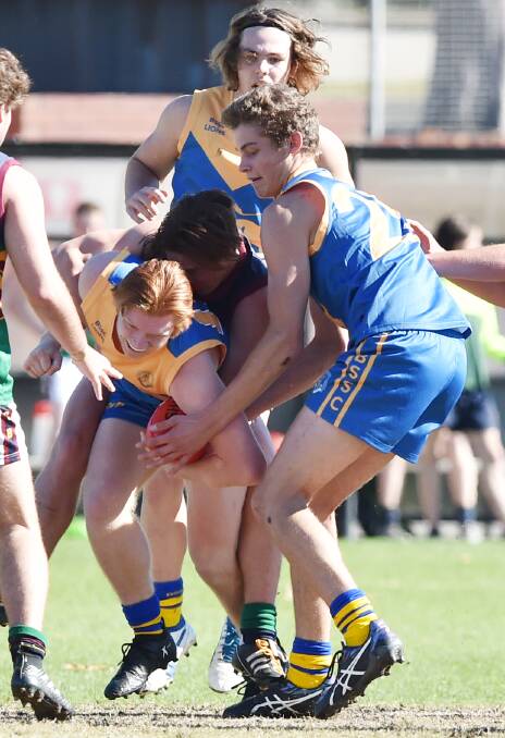 PRESSURE ON: Arch rivals Catholic College Bendigo and Bendigo Senior Secondary College battle at the QEO on Wednesday. Pictures: DARREN HOWE