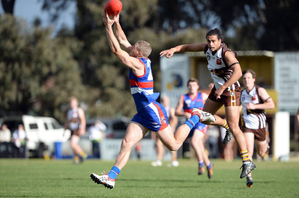 STRONG HANDS: North Bendigo forward Rhys Ford marks in front of Huntly's Ewen Pickles on Saturday. Ford kicked three goals for the Bulldogs. Picture: GLENN DANIELS