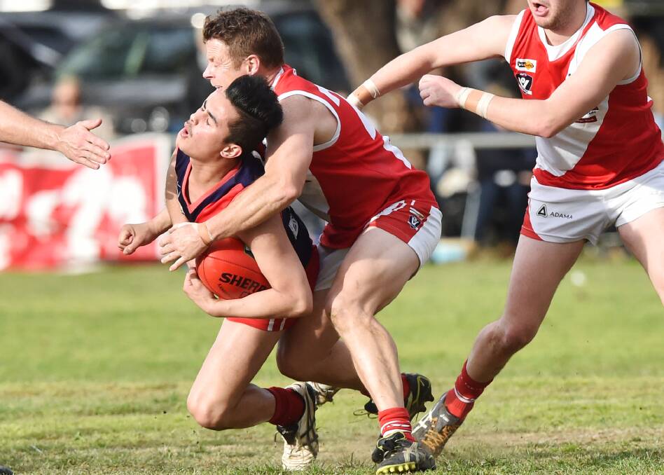 WRAPPED UP: Bridgewater's Deon Jones tackles Calivil United's Vinny Rodi. The Demons proved too good for the Mean Machine, winning by 34 points at Serpentine to claim their first flag since 2008. Picture: DARREN HOWE