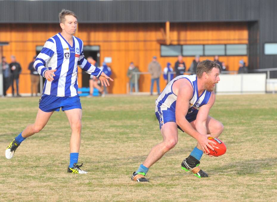 EXPERIENCED: Mitiamo's Aaron McKean takes possession of the ball with support from team-mate Daniel Allen during Saturday's 91-point victory over Maiden Gully YCW Eagles at Marist College. Picture: ADAM BOURKE