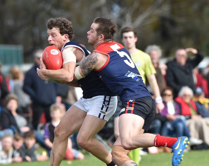 GOTCHA: Charlton's Anthony Judd is tackled by Wycheproof-Narraport's Andrew Mead-Harding. Picture: NONI HYETT