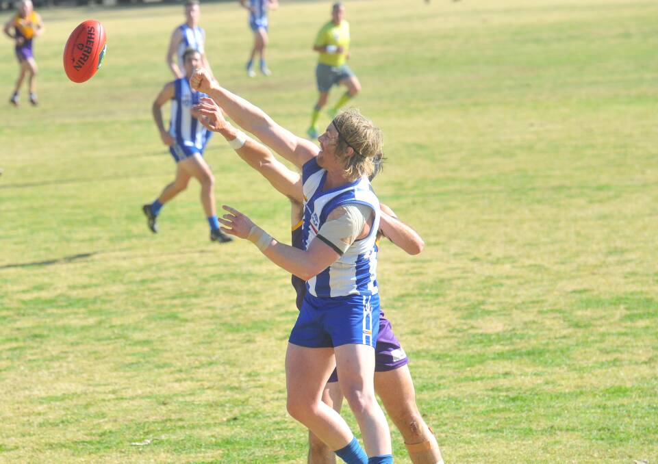 GOLDEN FIST: Mitiamo defender Tom Campbell punches the ball during Sunday's elimination final win.