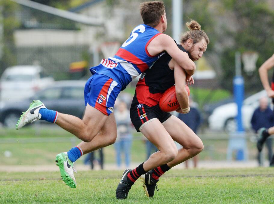 GOTCHA: North Bendigo's Jarrod Findlay lays a tackle on Leitchville-Gunbower's Hoby Bussey in the grand final rematch. Picture: DARREN HOWE