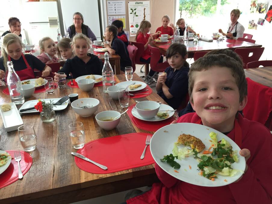 GENERATION OF COOKS: Heathcote Primary School Grade 3 student Kyle Bird with classmates at their bi-weekly kitchen-garden lunch – a of the students come from 'second-generation non-cooking families,'  organisers say. 