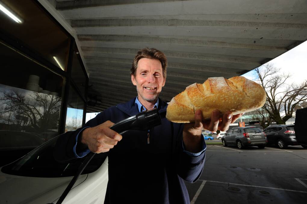 MORE DOUGH NEEDED: Laurie Whelan runs a bakery and one of two Tesla electric vehicle recharge stations – but as he is not the building's owner he is yet to switch to solar. Picture: NONI HYETT
