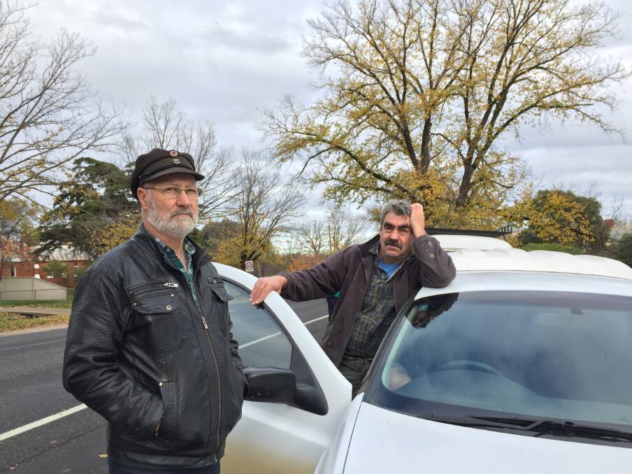 LONG DRIVE: Like all but a few residents, Colin Lamport and Michael Ruggles drive out of town for petrol, but the manager of the Newstead's free electric vehicle charging station says locals are increasingly looking at making the switch. Pictures: JOSEPH HINCHLIFFE