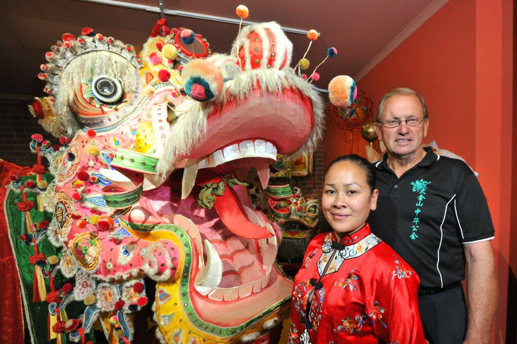RIOT OF COLOUR: Bendigo Chinese Association president Charles Lougoon and Noi Beck – the Chinese community has been contributing to Easter Parade for more than 100 years. Picture: NONI HYETT
