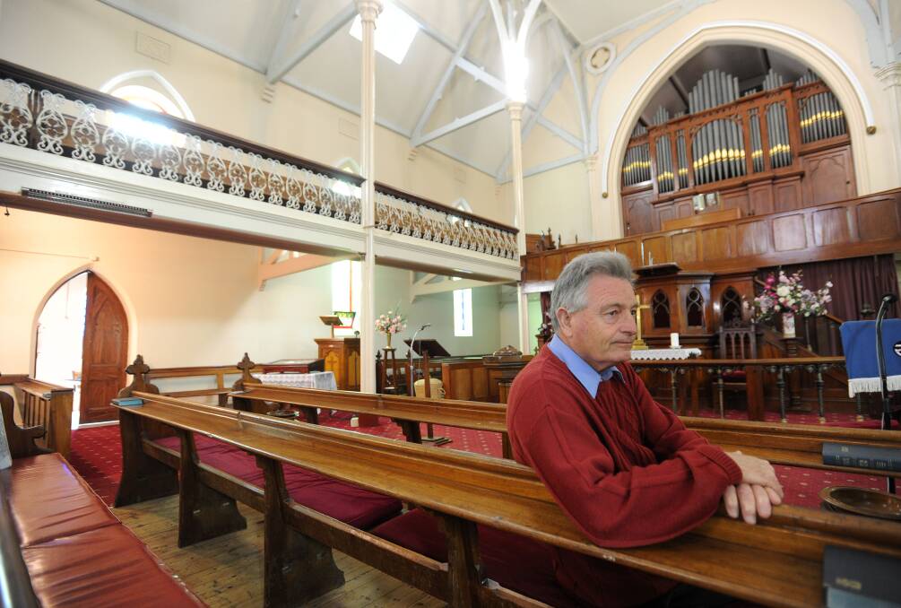 Mr Wright - now speaking as a private citizen - pictured on the pews in 2013 when the Golden Square Uniting Church was first put to market. Picture: JODIE WIEGARD
