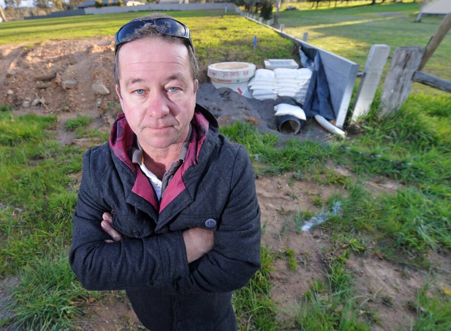 DRAIN PAIN: Truck driver Steve Pilcher and his family are one of eight households which may eventually fork out thousands to pay for the drainage upgrade. Picutre: DARREN HOWE