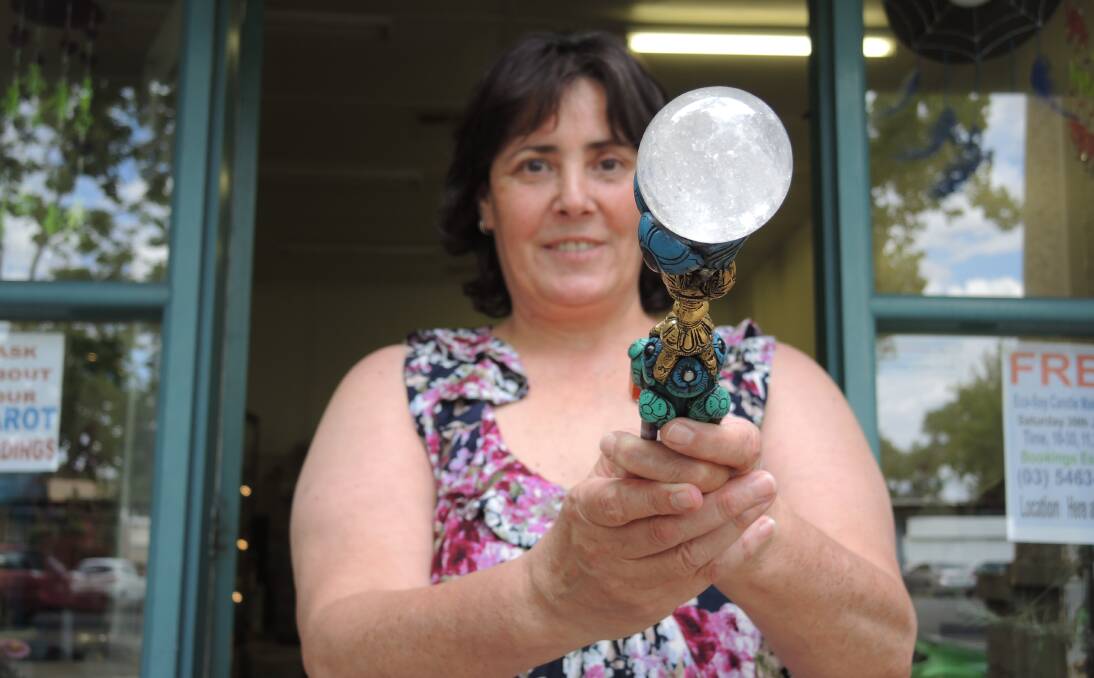 MAGIC WAND: Johanna Hobson holds a Tibetan healing wand in front of the gift store she hopes will draw the spiritual from across the region – 'there are a lot of healers in Bendigo' she says. Picture: JOSEPH HINCHLIFFE