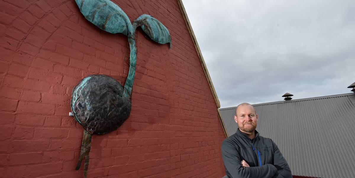 NOBLE AND DOYLE: Blacksmith John Doyle and a lawyer Peter Noble [pictured] teamed up to turn an old copper tank into a new piece of art for St Matthew's Church. Picture: JODIE WIEGARD