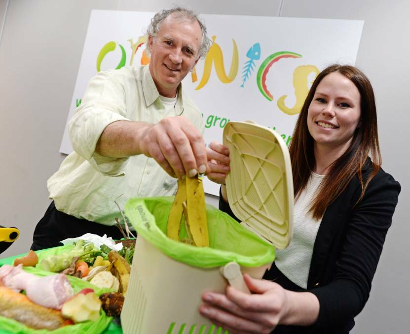 IN THE BIN: Waste services manager Simon Clay and organics project officer Bridgette McDougall were charged with monitoring the trial of the new organic waste wheelie bins. Picture: DARREN HOWE