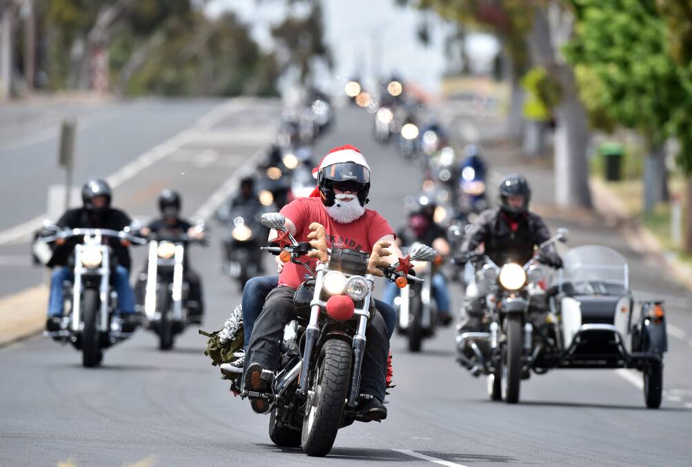 SONS OF CHARITY: Allies Motorcycle Club Bendigo members ride through the city's streets to collect toys and cash for those in need  – more pictures from the Bendigo Motorcycle Toy Run online. Picture: GLENN DANIELS