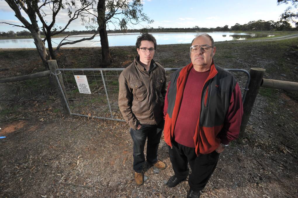 DISGUSTED: Woodvale Progress Association president Brendan Bartlett and Unity Mining Environmental Review Committee community representative Woodvale Gary Davis at the evaporation ponds. Picture: NONI HYETT