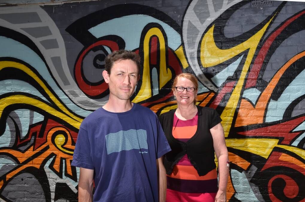 PSYCHEDELIC: Artist Brendan Purser and Arnold Street gallery owner Susan McMinn in front of Mr Purser's piece. Picture: NONI HYETT