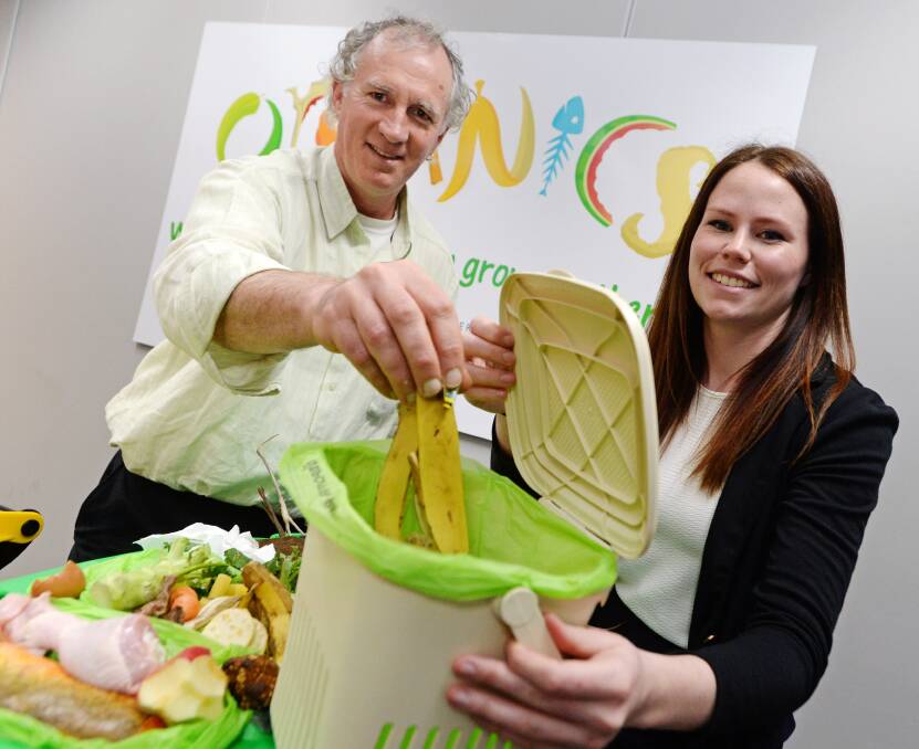 IN THE BIN: Waste services manager Simon Clay and organics project officer Bridgette McDougall will be charged with monitoring the trial of the new organic waste wheelie bins. Picture: DARREN HOWE