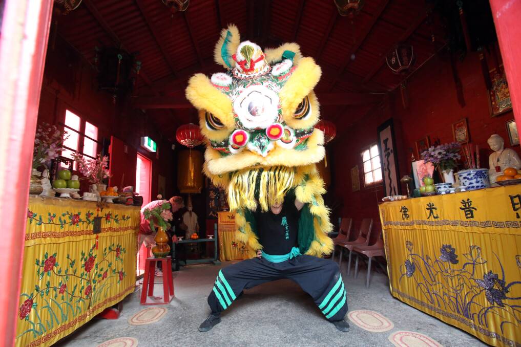 ENTER THE DRAGON: This dragon burst from the doors of the Joss House to put on one of its much loved performances. Pictures: GLENN DANIELS