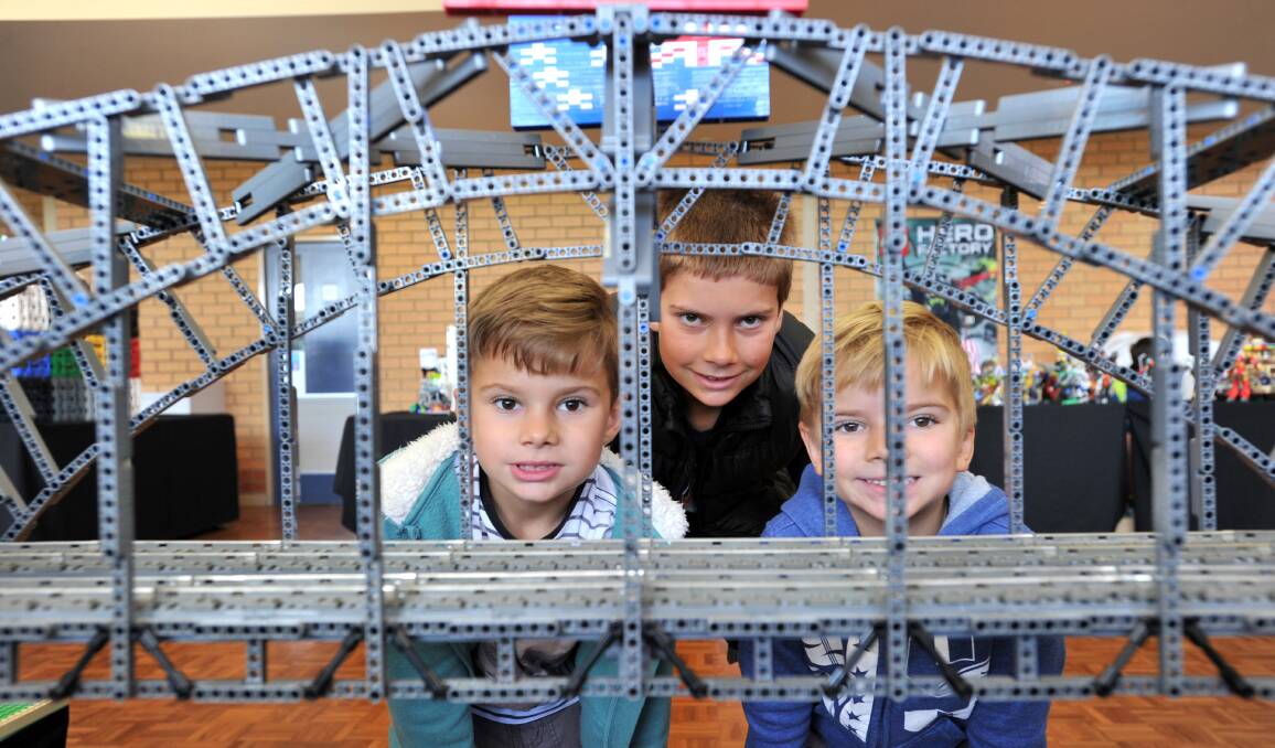 SYDNEY HARBOUR BRIDGE: Ash, Josh and Max Curnow behind the bridge which took the Piggotts more than 200 hours to design and build. Pictures NONI HYETT