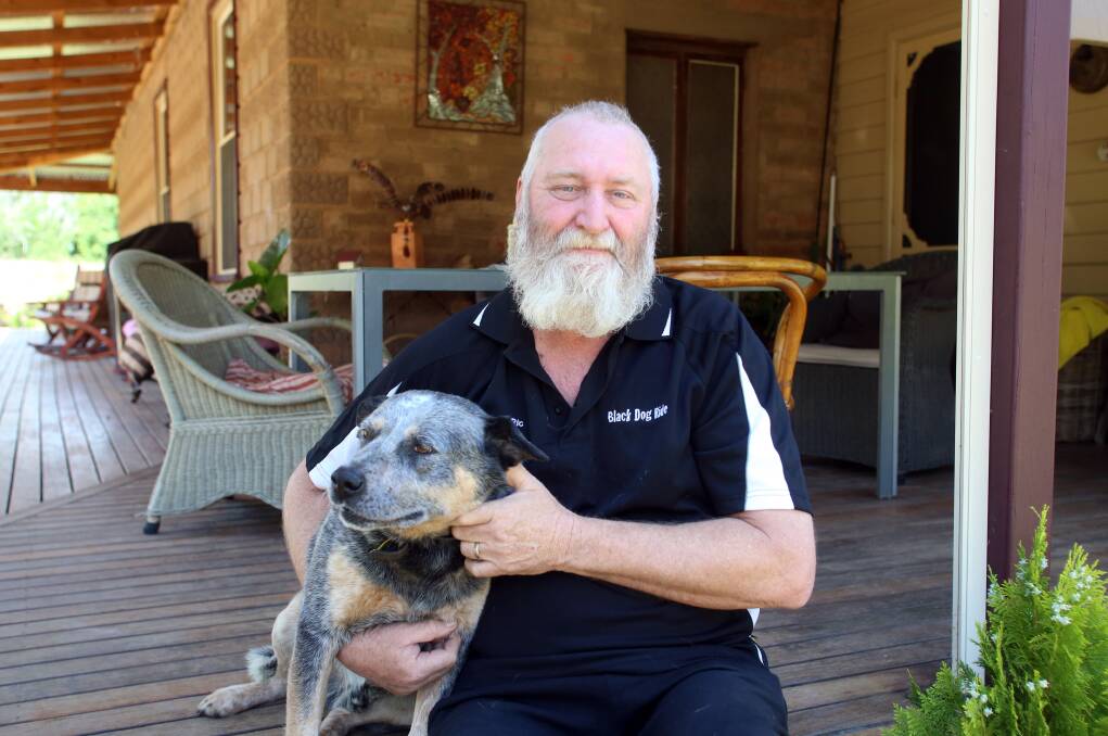 Mental health advocate Ric Raftis and dog Boof in their Wedderburn home.
