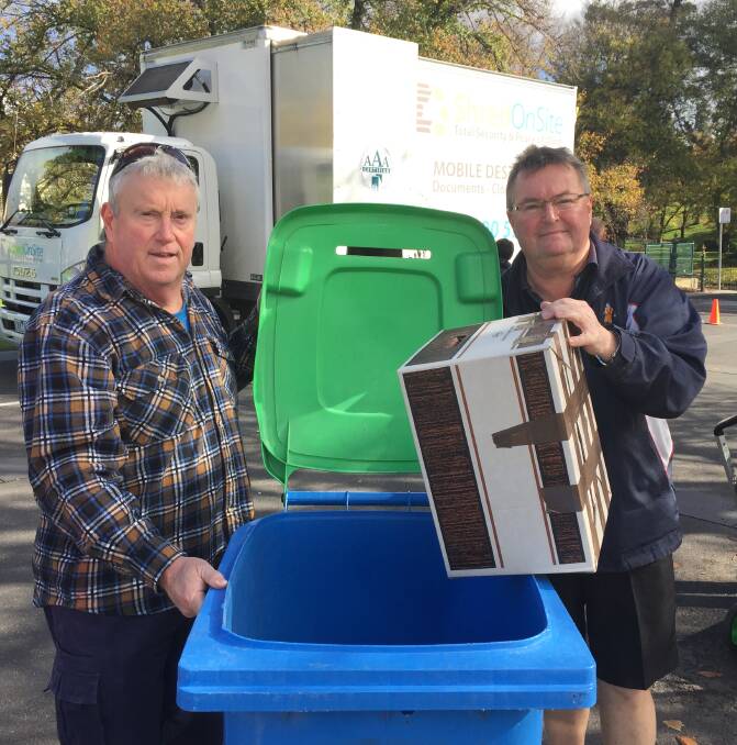 BIN IT SAFE: Don and Greg Sherman use the Shred Fest event to get rid of 15-years worth of sensitive documents. Picture: JOSEPH HINCHLIFFE