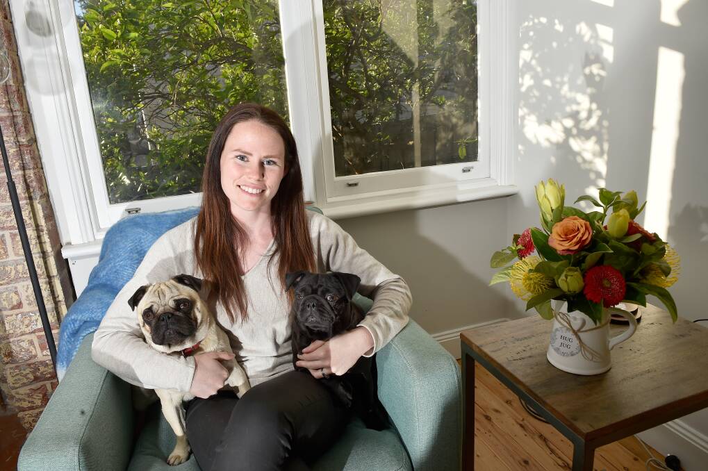 OUTSTANDING: Award-winning environmental professional Bridgette McDougall in her North Bendigo home with pugs Stella and Percy. Picture: NONI HYETT