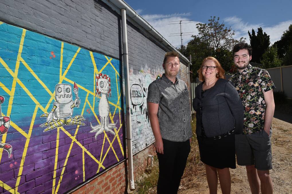 BY APPLICATION ONLY: Gallery owner Susan McMinn with street artists ‘Mr Dimples’  and ‘Marcsi' who will commission street artists to paint the wall. Picture: NONI HYETT
