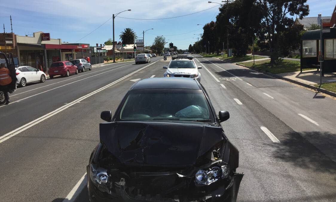 WRITE-OFF: The black sedan which failed to stop was towed from the scene on Napier Street. 